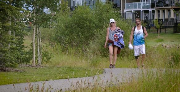 couple walking on pathway system in Okotoks