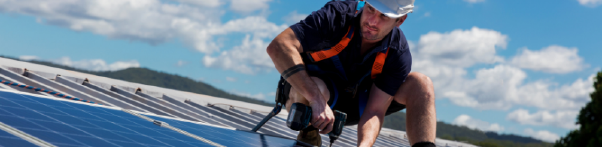 man on roof installing solar panels