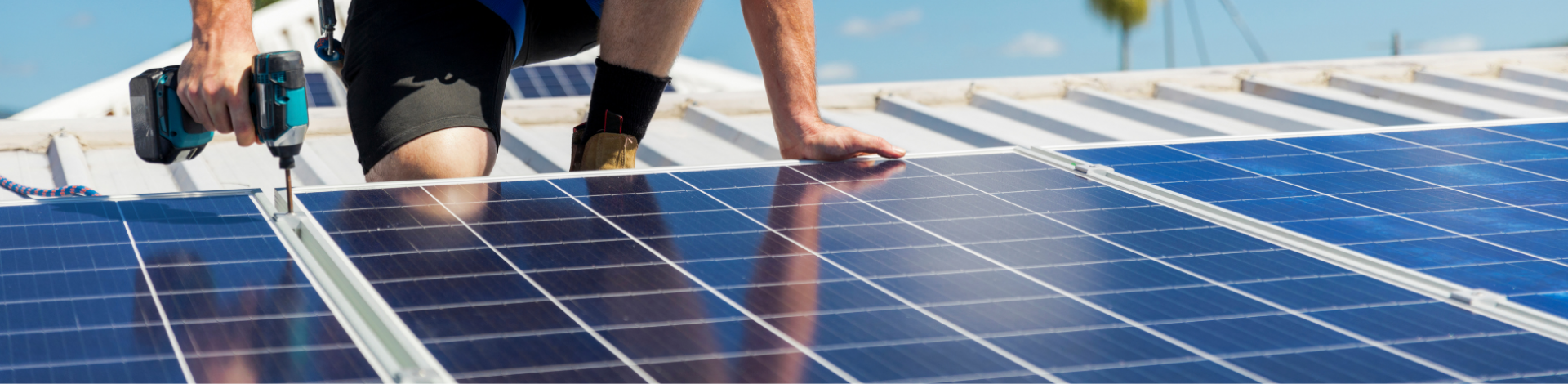 man on roof installing solar panels