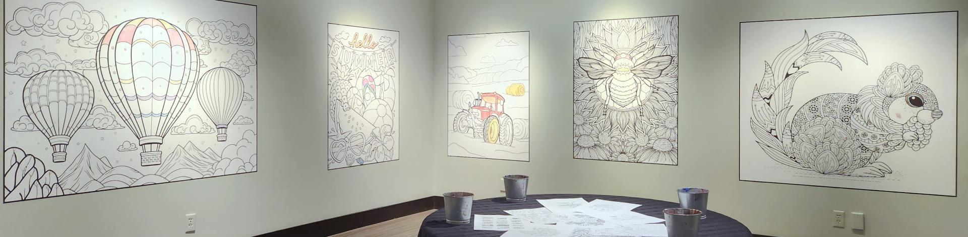 Colouring sheets hung on walls in small gallery