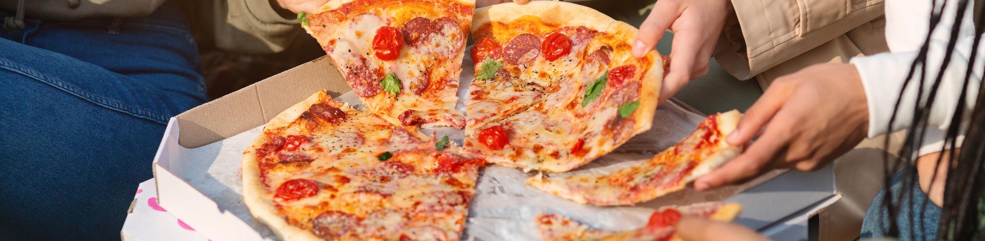 close-up-take-away-pizza-teenagers-hands