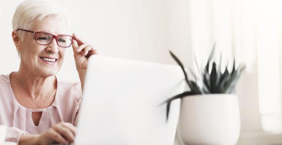 older adult lady working on her laptop