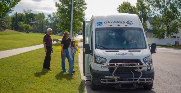 People waiting to get on Okotoks transit vehicle