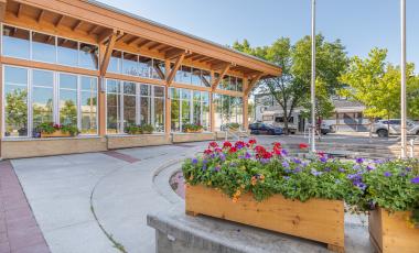 Okotoks Municipal Centre in summer with flowers blooming out front