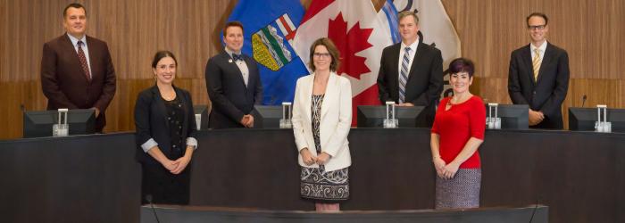 member of 2021 to 2025 Okotoks Town Council standing in Council Chambers