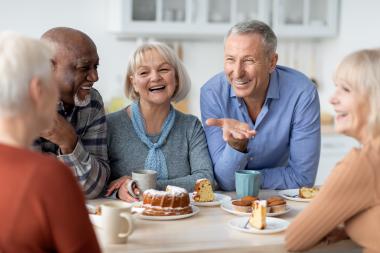 Group of seniors enjoying coffee and snacks