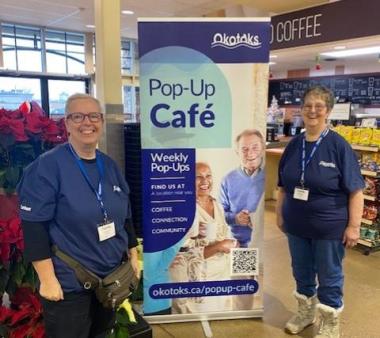 Pop up cafe banner with smiling volunteers